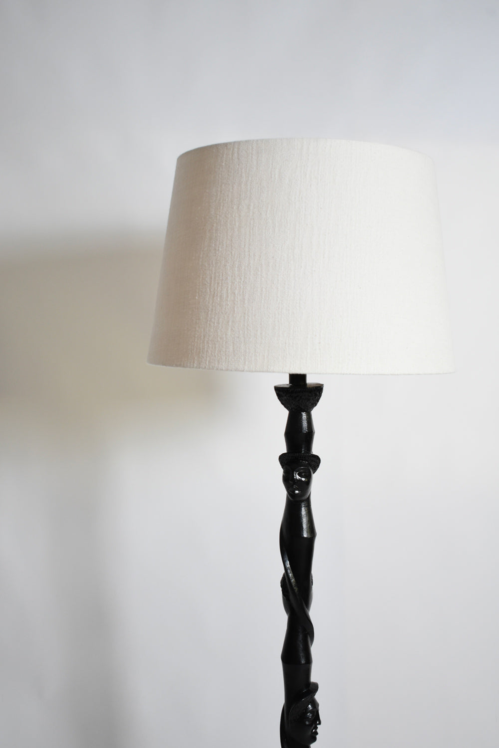 Africanist ebonised wood floor lamp, 1970s.