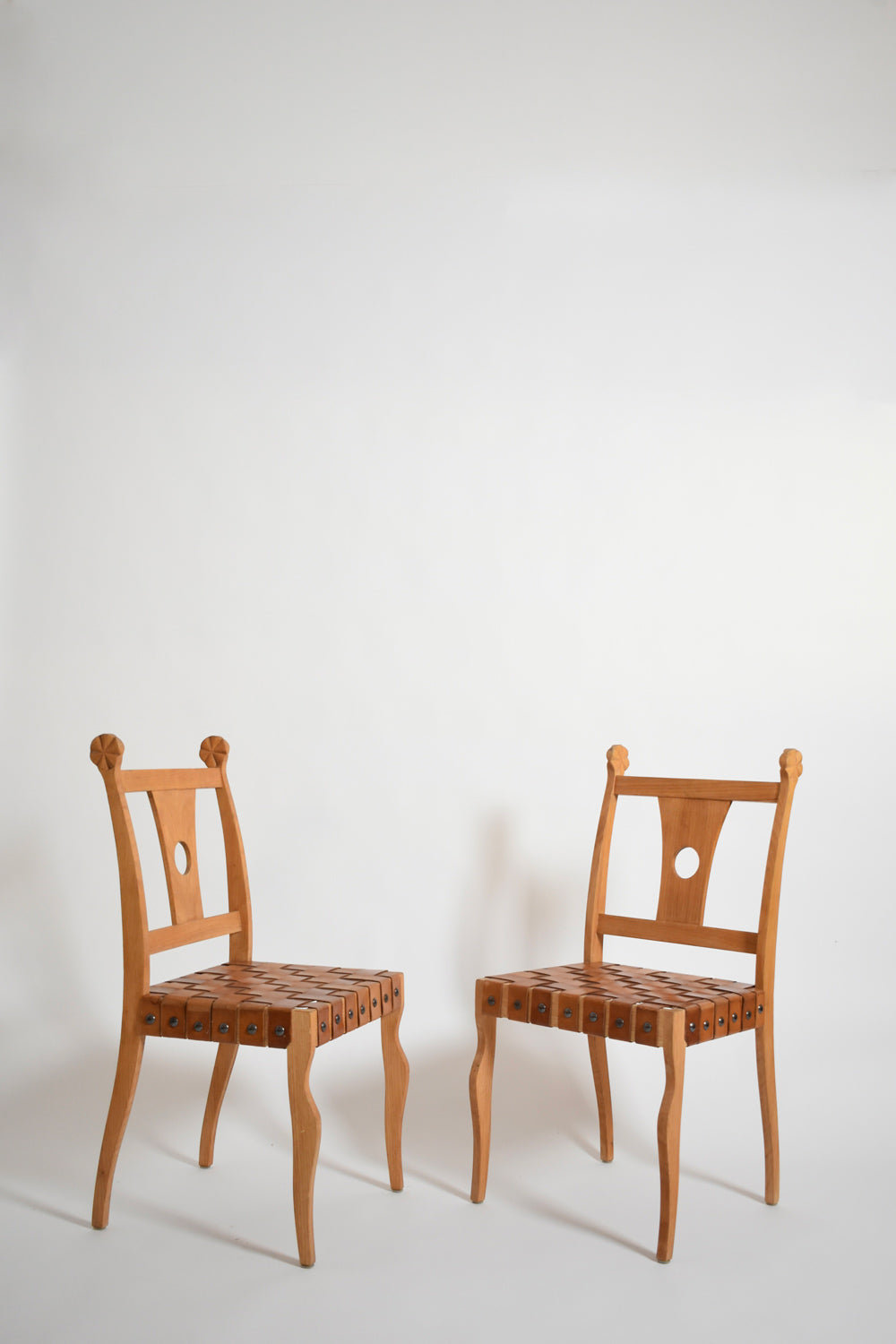 Pair of etruscan oak and leather chairs, 1970s.