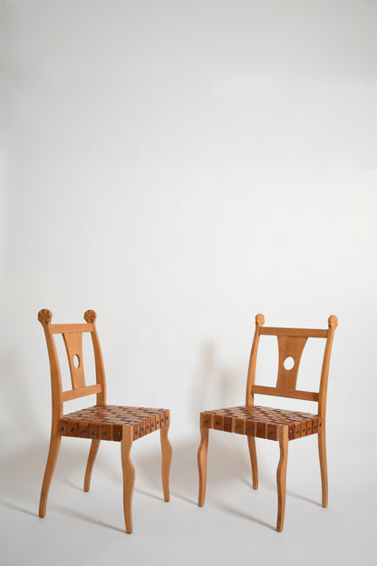 Pair of etruscan oak and leather chairs, 1970s.
