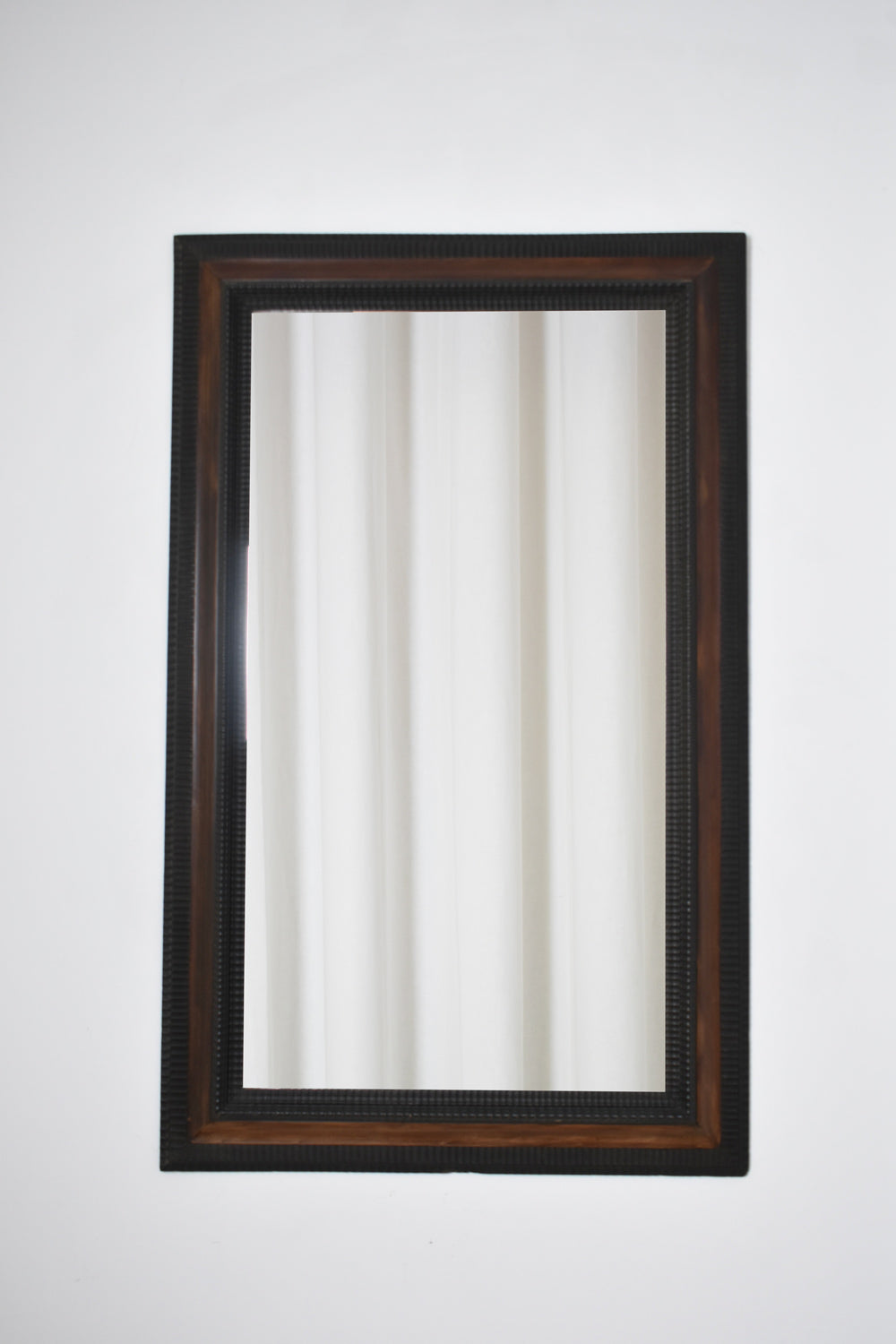 Carved ebonised wood mirror and trompe l'oeil turshell, XIXth c.