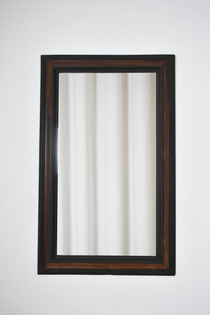 Carved ebonised wood mirror and trompe l'oeil turshell, XIXth c.