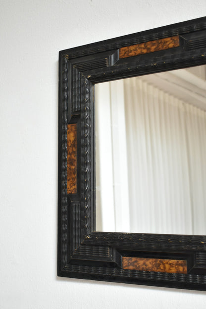 Pair of carved ebonised wood and trompe l'oeil turshell mirrors, XIXth c.