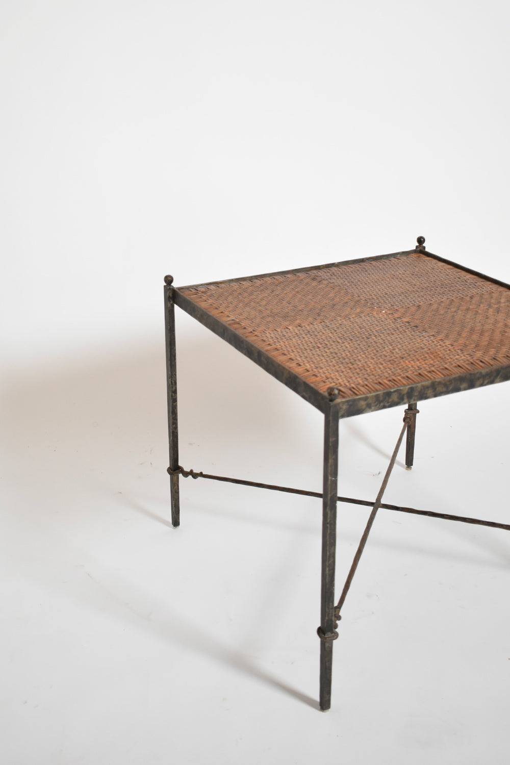 Pair of wrought iron and wicker side tables, 1970s.