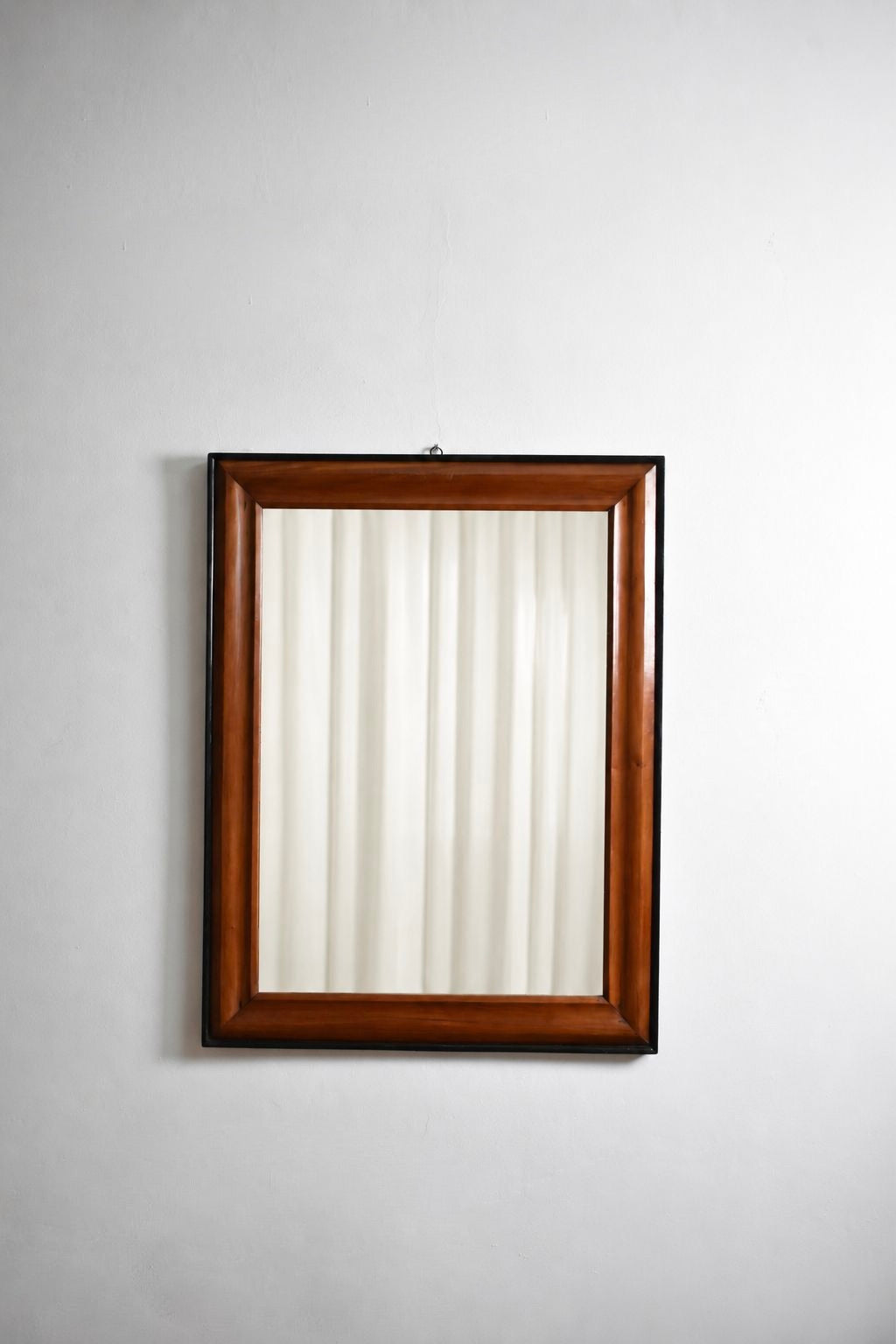 Pair of bicolor wood and ebonised wood mirrors, XIXth c.