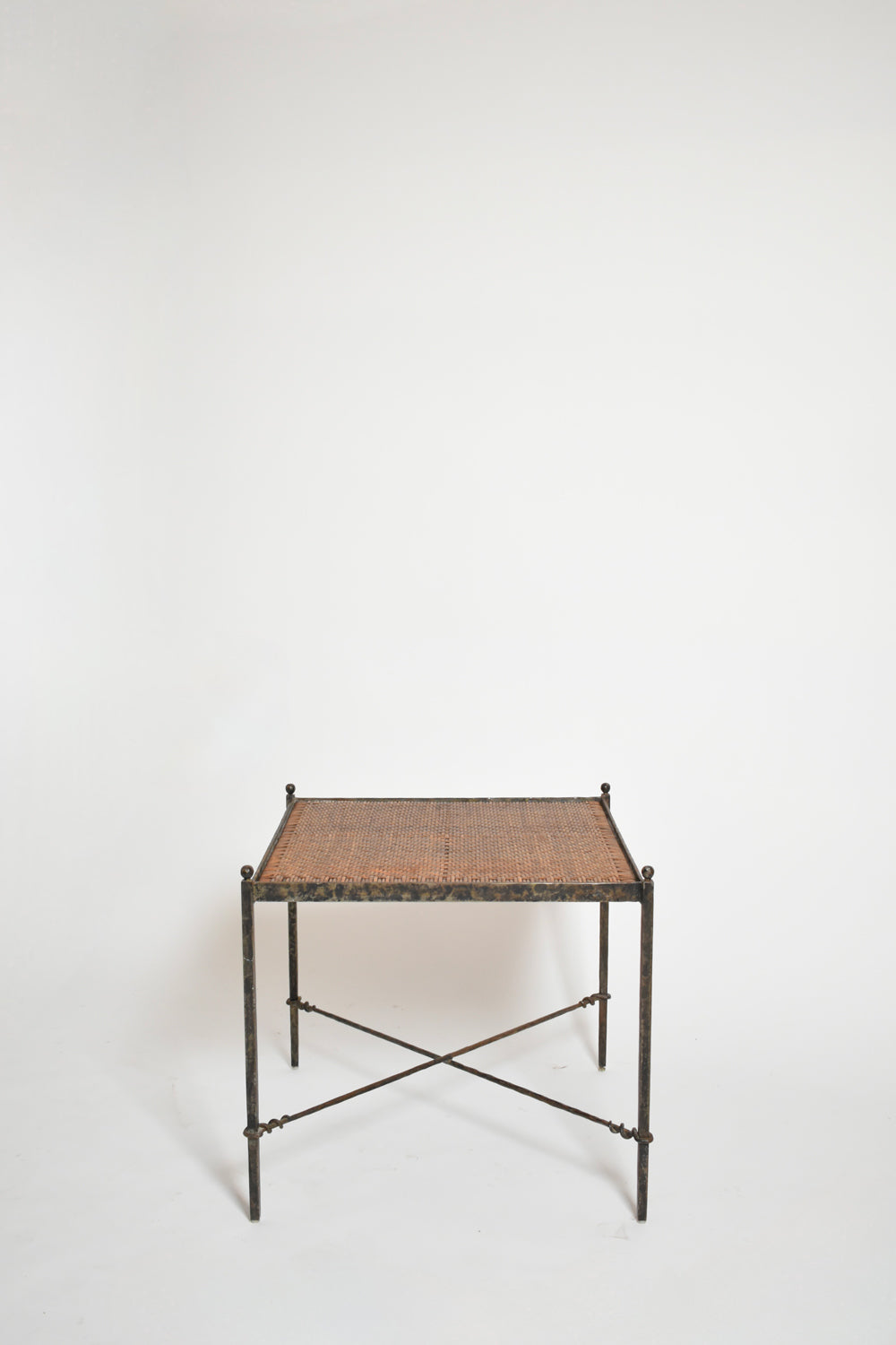 Pair of wrought iron and wicker side tables, 1970s.